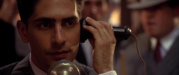 Movie still from “Last Man Standing” (1996), directed by Walter Hill – A person talking on a cell phone; Close Up shot, Low angle