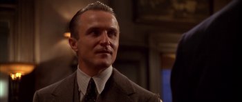 Movie still from “Last Man Standing” (1996), directed by Walter Hill – A man in a suit and tie looking to his left; Close Up shot, Low angle