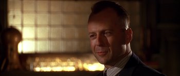 Movie still from “Last Man Standing” (1996), directed by Walter Hill – A person wearing a suit and tie; Close Up shot, Low angle