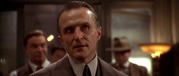 Movie still from “Last Man Standing” (1996), directed by Walter Hill – A man in a suit and a tie; Close Up shot, Low angle