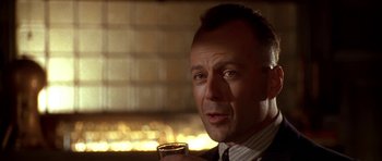 Movie still from “Last Man Standing” (1996), directed by Walter Hill – A person holding a glass of wine; Close Up shot, Low angle