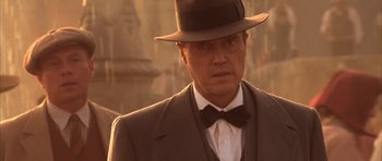 Movie still from “Last Man Standing” (1996), directed by Walter Hill – A person wearing a suit and a hat; Close Up shot, Low angle