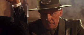 Movie still from “Last Man Standing” (1996), directed by Walter Hill – An older man wearing a hat and a suit; Close Up shot, Low angle