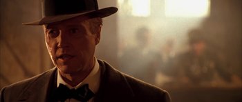 Movie still from “Last Man Standing” (1996), directed by Walter Hill – A person wearing a suit and a hat; Close Up shot, Over the shoulder angle