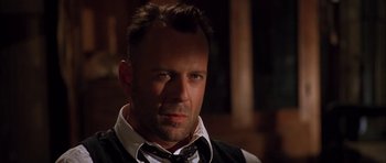 Movie still from “Last Man Standing” (1996), directed by Walter Hill – A person wearing a suit and tie; Close Up shot, Low angle