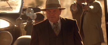 Movie still from “Last Man Standing” (1996), directed by Walter Hill – A man wearing a suit and a hat; Close Up shot, Low angle