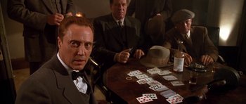 Movie still from “Last Man Standing” (1996), directed by Walter Hill – A man sitting at a table with cards in front of him; Medium shot, Over the shoulder angle