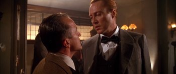 Movie still from “Last Man Standing” (1996), directed by Walter Hill – Two men in suits and bow ties talking to each other; Medium shot, Low angle