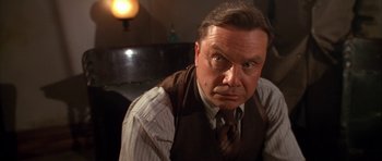 Movie still from “Last Man Standing” (1996), directed by Walter Hill – An older man wearing a vest and a tie; Close Up shot, Low angle