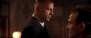 Movie still from “Last Man Standing” (1996), directed by Walter Hill – A man in a suit and tie looking to his left; Close Up shot, Low angle