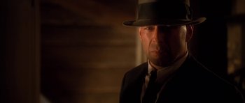 Movie still from “Last Man Standing” (1996), directed by Walter Hill – A person wearing a suit and a hat; Close Up shot, Low angle