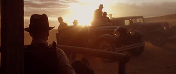 Movie still from “Last Man Standing” (1996), directed by Walter Hill – A group of men riding in the back of an old truck; Medium shot, Low angle