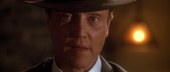 Movie still from “Last Man Standing” (1996), directed by Walter Hill – A person wearing a suit and a hat; Close Up shot, Low angle