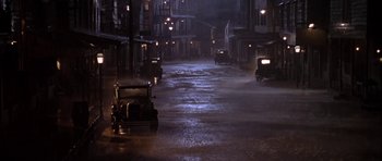 Movie still from “Last Man Standing” (1996), directed by Walter Hill – A street scene with cars driving down the road; Extreme Wide shot, High angle
