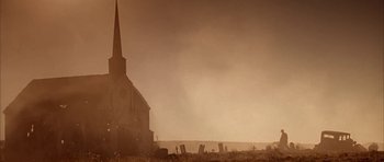 Movie still from “Last Man Standing” (1996), directed by Walter Hill – An old church with a steeple in the middle of a field; Extreme Wide shot, Low angle