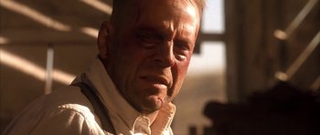 Movie still from “Last Man Standing” (1996), directed by Walter Hill – A person with a bruise on his face; Close Up shot, Low angle