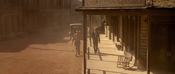 Movie still from “Last Man Standing” (1996), directed by Walter Hill – Two men walking down the street in a western town; Wide shot, High angle