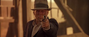 Movie still from “Last Man Standing” (1996), directed by Walter Hill – An older man in a hat and a suit points a gun; Close Up shot, Low angle