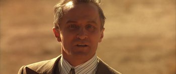 Movie still from “Last Man Standing” (1996), directed by Walter Hill – A person wearing a suit and tie; Close Up shot, Low angle