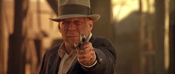Movie still from “Last Man Standing” (1996), directed by Walter Hill – An older man in a hat is holding a gun; Close Up shot, Low angle