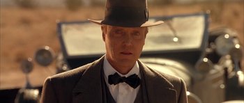 Movie still from “Last Man Standing” (1996), directed by Walter Hill – A person wearing a suit and hat; Close Up shot, Low angle