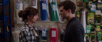 Movie still from “Fifty Shades of Grey” (2015), directed by Sam Taylor-Johnson – A man and a woman standing next to each other; Close Up shot, Over the shoulder angle