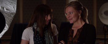 Movie still from “Fifty Shades of Grey” (2015), directed by Sam Taylor-Johnson – Two women talking to each other in a room; Close Up shot, Over the shoulder angle
