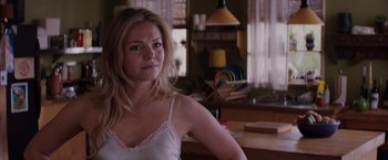 Movie still from “Fifty Shades of Grey” (2015), directed by Sam Taylor-Johnson – A woman standing in front of a window in a room; Close Up shot, Over the shoulder angle