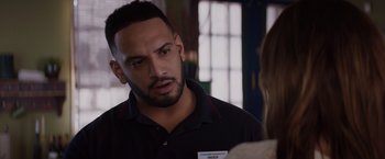 Movie still from “Fifty Shades of Grey” (2015), directed by Sam Taylor-Johnson – A man in a black shirt talking to a woman in a black shirt; Close Up shot, Over the shoulder angle