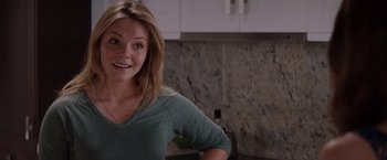 Movie still from “Fifty Shades of Grey” (2015), directed by Sam Taylor-Johnson – A beautiful young lady standing in front of a kitchen counter; Close Up shot, Over the shoulder angle