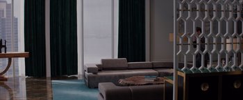 A living room filled with furniture next to a large window