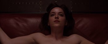 Movie still from “Fifty Shades of Grey” (2015), directed by Sam Taylor-Johnson – A woman laying on top of a couch with her eyes closed; Close Up shot, Overhead angle
