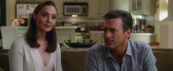 Movie still from “Keeping Up with the Joneses” (2016), directed by Greg Mottola – A man and a woman sitting in a living room next to each other; Close Up shot, Over the shoulder angle