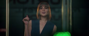 Movie still from “Keeping Up with the Joneses” (2016), directed by Greg Mottola – A woman in a black dress is standing in front of a green ball; Close Up shot, Over the shoulder angle