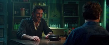 Movie still from “Keeping Up with the Joneses” (2016), directed by Greg Mottola – A man sitting at a table with a bowl of food; Medium shot, Over the shoulder angle