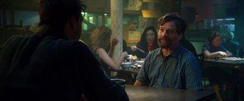 Movie still from “Keeping Up with the Joneses” (2016), directed by Greg Mottola – A group of people sitting at a table in a restaurant; Medium shot, Over the shoulder angle