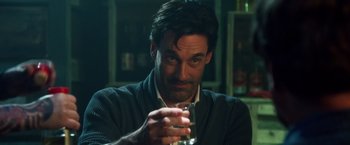Movie still from “Keeping Up with the Joneses” (2016), directed by Greg Mottola – A person holding a glass of water; Close Up shot, Over the shoulder angle