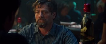 Movie still from “Keeping Up with the Joneses” (2016), directed by Greg Mottola – A person sitting at a table; Close Up shot, Over the shoulder angle