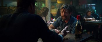 Movie still from “Keeping Up with the Joneses” (2016), directed by Greg Mottola – Two men sitting at a table talking to each other; Close Up shot, Over the shoulder angle