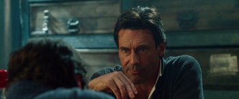 Movie still from “Keeping Up with the Joneses” (2016), directed by Greg Mottola – A person sitting with his hand on his chin; Close Up shot, Over the shoulder angle