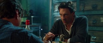 Movie still from “Keeping Up with the Joneses” (2016), directed by Greg Mottola – A man sitting at a table with chopsticks in front of him; Close Up shot, Over the shoulder angle