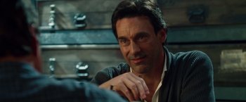 Movie still from “Keeping Up with the Joneses” (2016), directed by Greg Mottola – A person sitting in front of a wall; Close Up shot, Over the shoulder angle