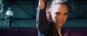 Movie still from “Keeping Up with the Joneses” (2016), directed by Greg Mottola – A woman is holding her hand up in the air; Close Up shot, Over the shoulder angle