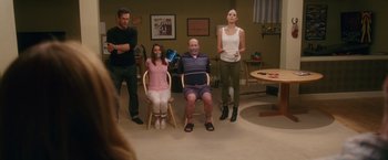 Movie still from “Keeping Up with the Joneses” (2016), directed by Greg Mottola – A group of people standing in a living room; Wide shot, Over the shoulder angle