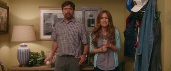 Movie still from “Keeping Up with the Joneses” (2016), directed by Greg Mottola – A man and a woman standing next to each other in a room; Medium shot, Over the shoulder angle