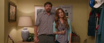 Movie still from “Keeping Up with the Joneses” (2016), directed by Greg Mottola – A man and a woman standing next to each other in a room; Medium shot, Over the shoulder angle