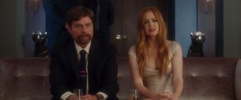 Movie still from “Keeping Up with the Joneses” (2016), directed by Greg Mottola – A man and a woman sitting at a dinner table; Medium shot, Over the shoulder angle