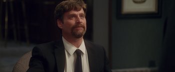 Movie still from “Keeping Up with the Joneses” (2016), directed by Greg Mottola – A person wearing a suit and tie; Close Up shot, Over the shoulder angle