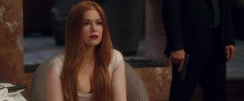 Movie still from “Keeping Up with the Joneses” (2016), directed by Greg Mottola – A woman with long red hair sitting in front of a man; Close Up shot, Over the shoulder angle