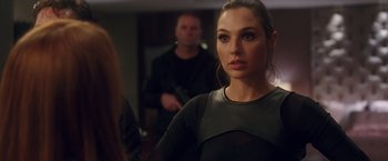 Movie still from “Keeping Up with the Joneses” (2016), directed by Greg Mottola – A beautiful woman in a black dress looking at the camera; Close Up shot, Over the shoulder angle